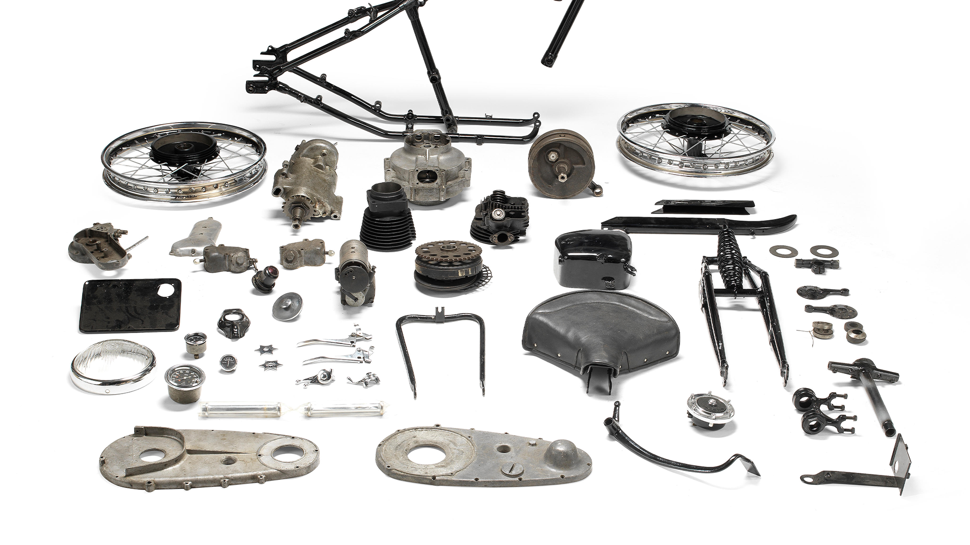 Collection of Harley-Davidson motorcycle parts on a white background